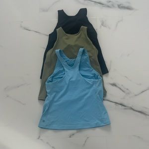 3 medium Athleta Conscious tanks with built in bra